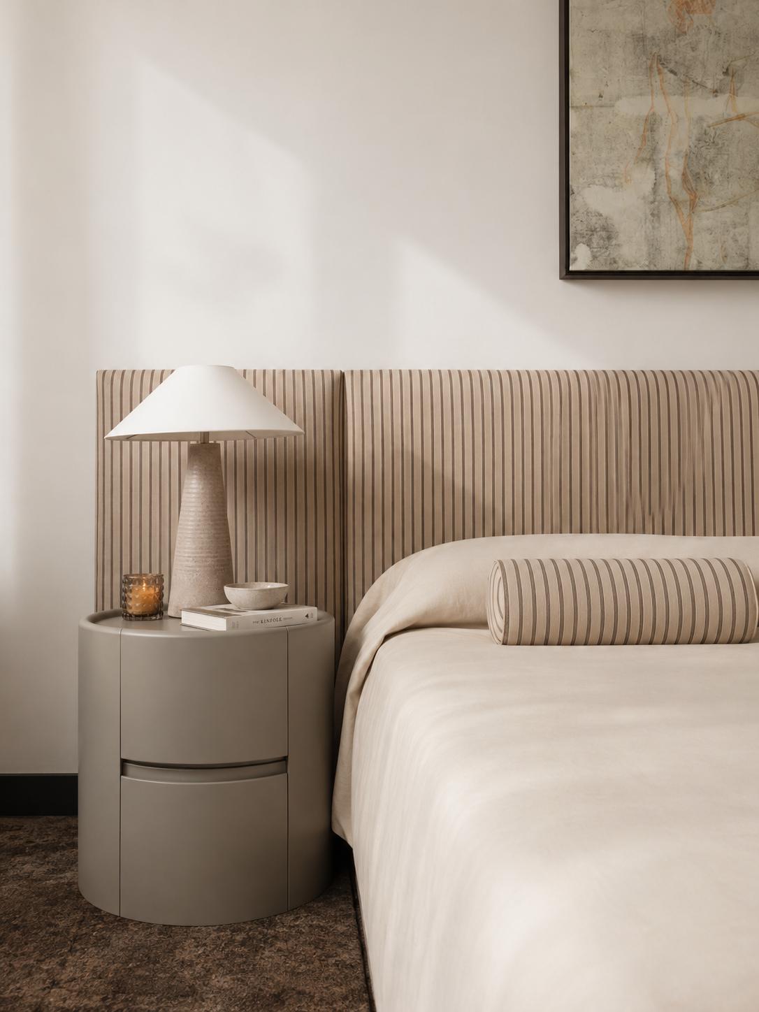 Mesa de luz Córdoba en gris piedra junto a la cama, con la junta horizontal de los cajones a la vista